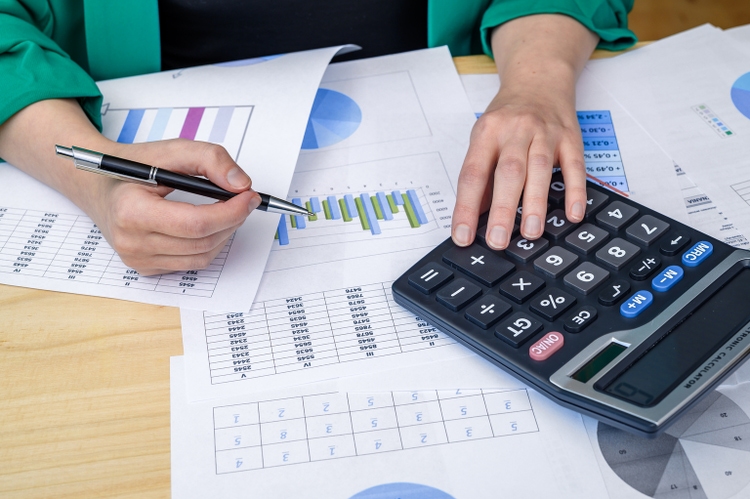 An accountant at work analyzes financial data and calculates the profitability of investments